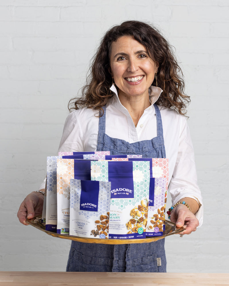 Photo of Tasya Kelen, Founder & CEO of Isadore Nuts holding a tray of nuts.